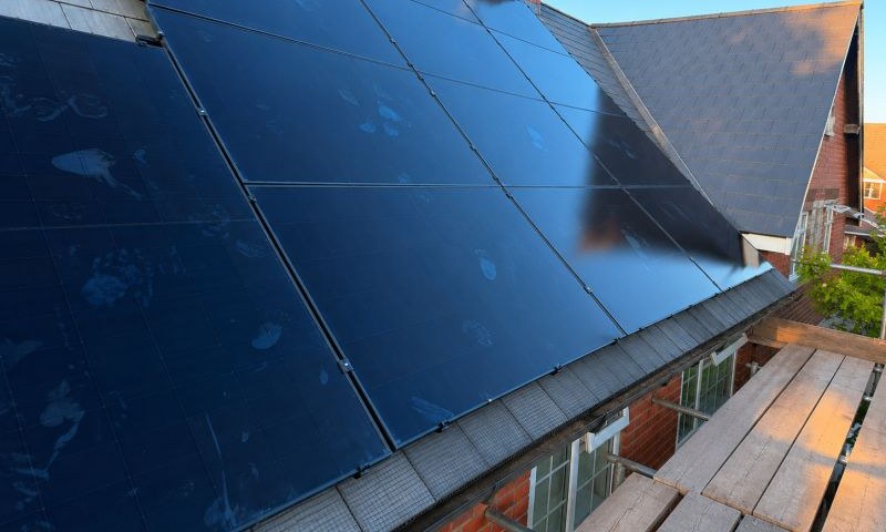 A big all-black solar array on a slate roof